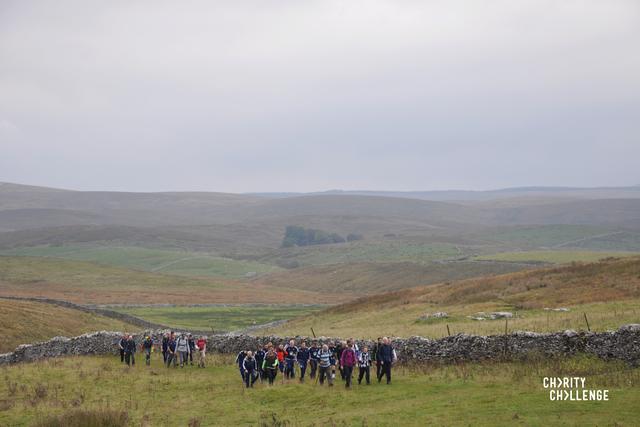 Photo from the Yorkshire 3 peaks challenge with misty horizon and people trekking