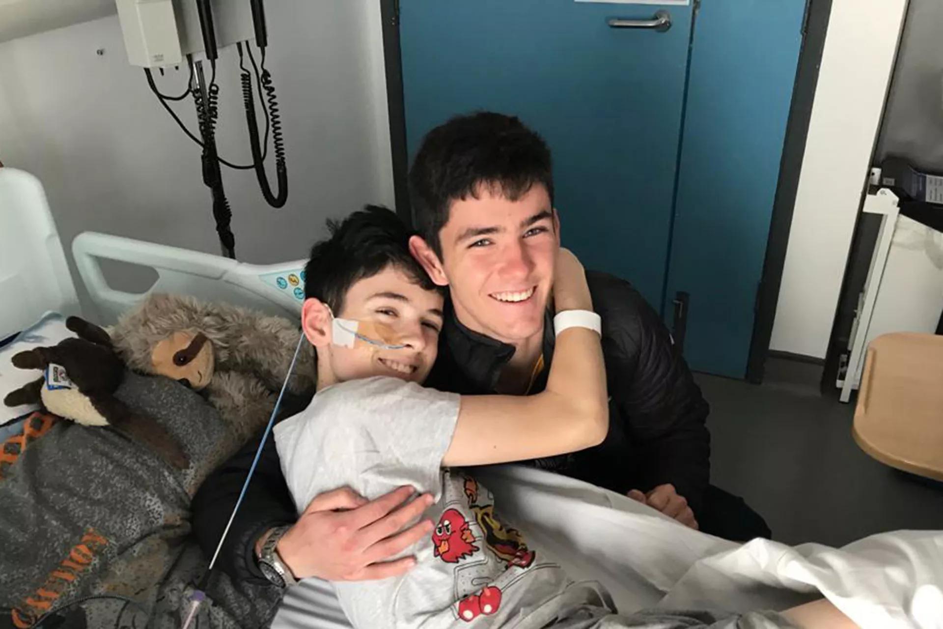 Daniel, in hospital, with his brother James.