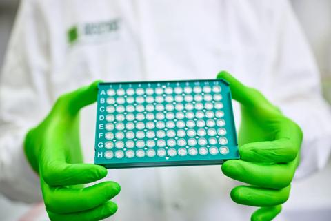 Researcher displaying a full tube rack