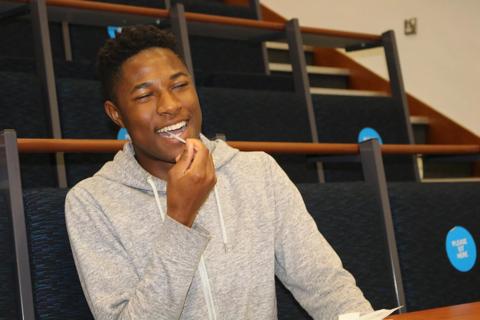 Young Black male swabbing his cheek at the Marrow Conference