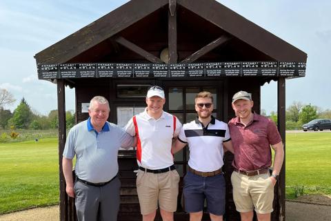 Damon and fellow golfers standing outside with their arms around each other