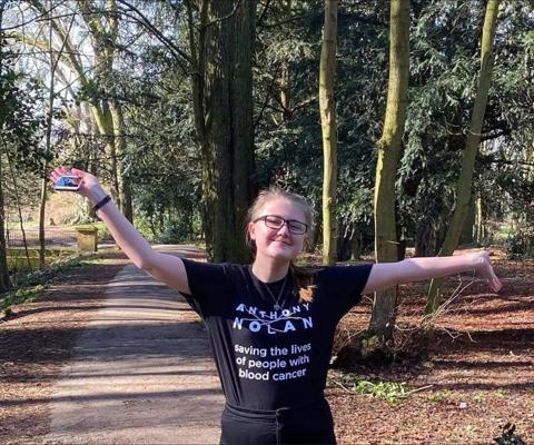 A young woman in an Anthony Nolan tshirt, raising funds with by joining a challenge event.