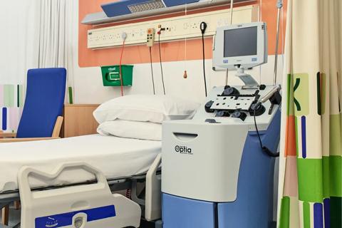 Banner image of an empty donor bed within Anthony Nolan's Cell Collection Centre. Along with colourful branded curtains.