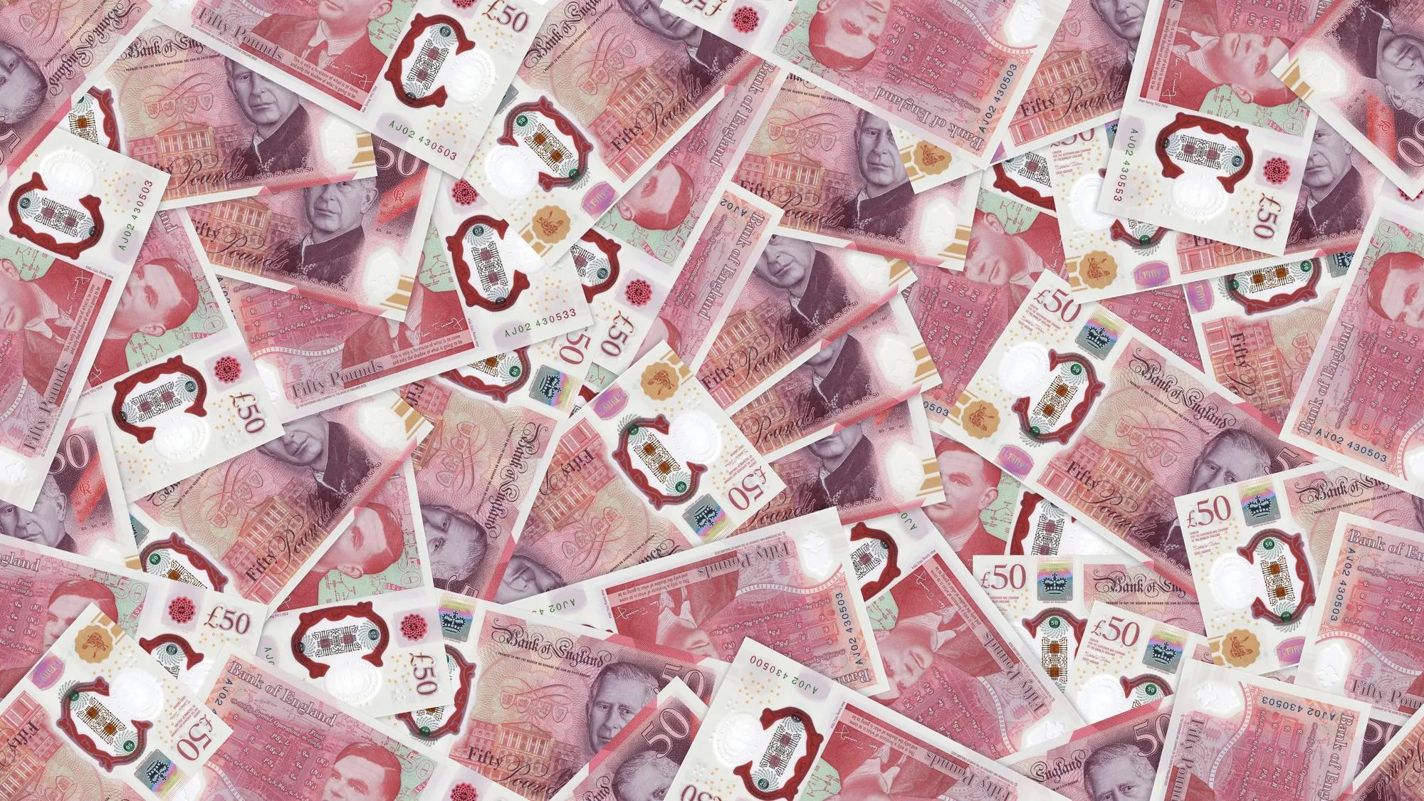 An aerial view of a pile of scattered £50 notes