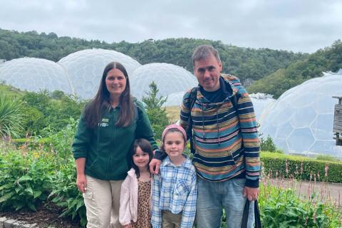 Jen, her husband and two young daughters standing in front of the Eden Project domes.