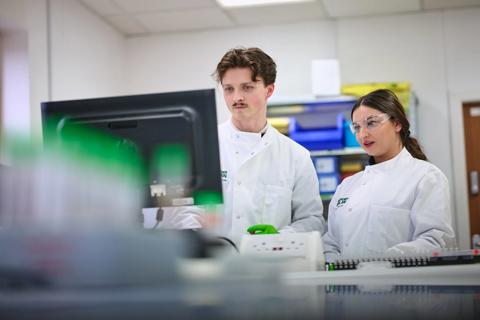 Researchers using a lab computer