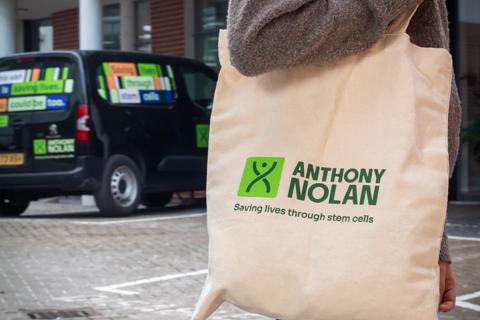 Person carrying Anthony Nolan branded tote bag