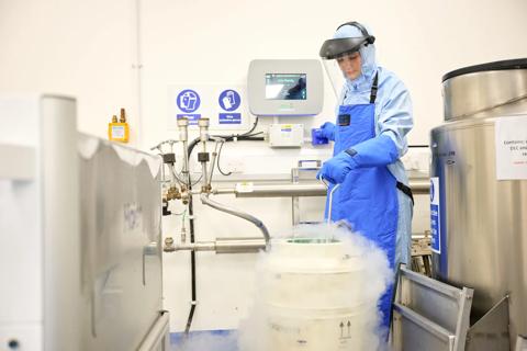 Researcher checking the levels of a  small cryogenic tank
