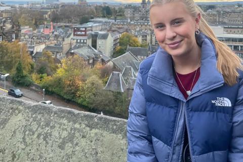a young woman with blonde hair in a blue coat