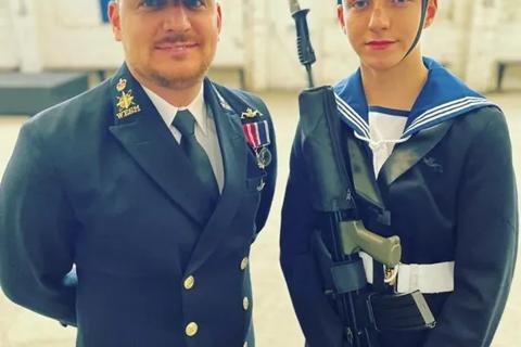 Charlie, a young man standing with his dad in their Royal Navy uniforms