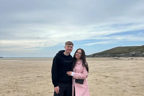 Ben (l) and Fran (r) smiling on the beach