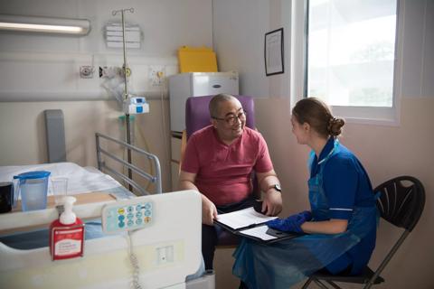Patient (Xing Zhang) in Hospital ward with CNS Sarah Ware
