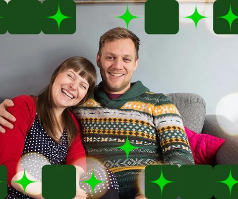 Stem cell recipient Jo Kelly and her husband on their sofa in a festive setting