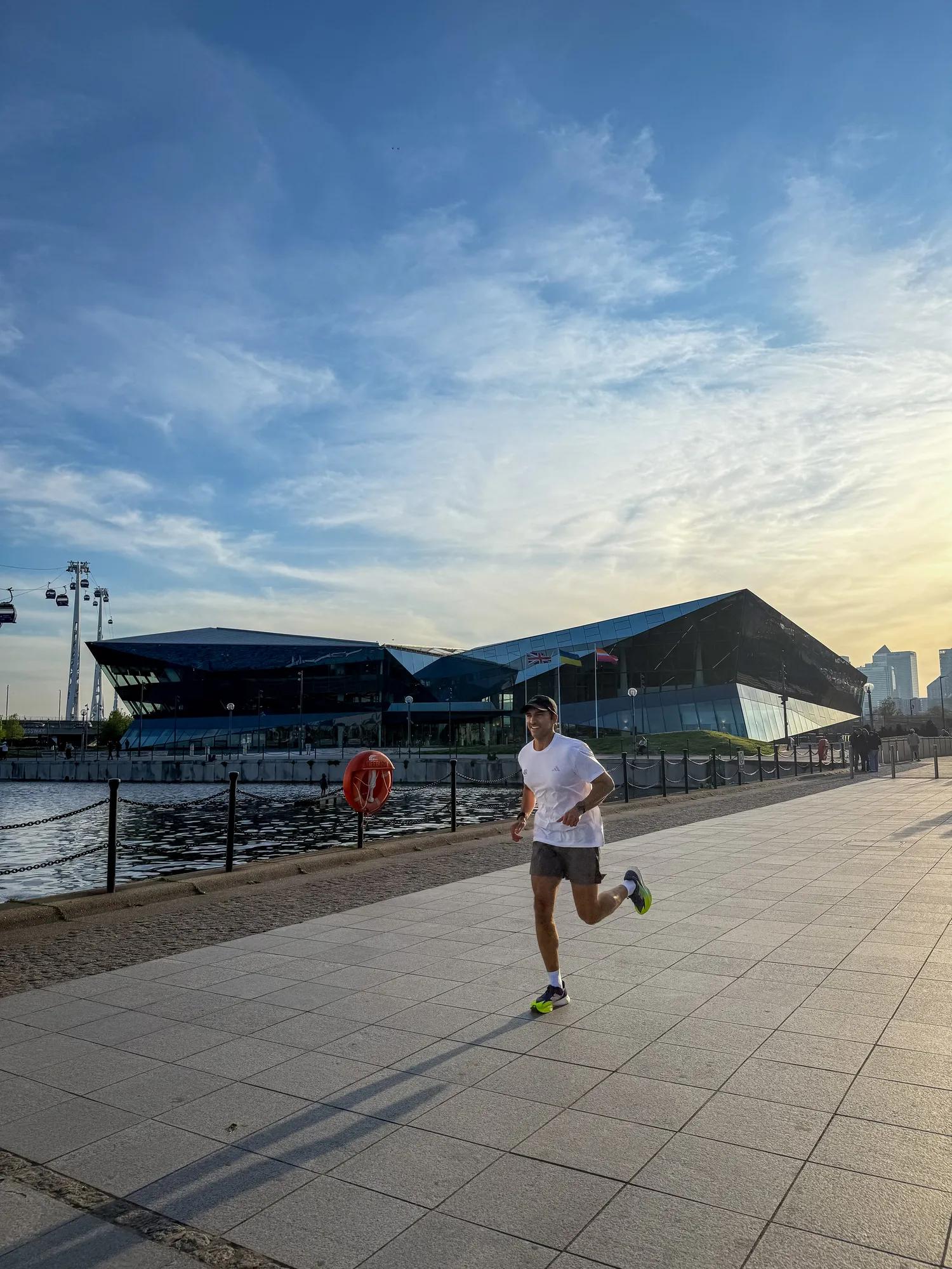 Kash running in a white t-shirt and black shorts