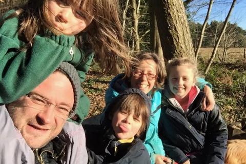 Selfie of Ginny, her husband and children on a sunny walk in the woods