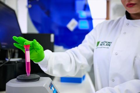 Researcher testing a DNA sample using specialised lab equipment