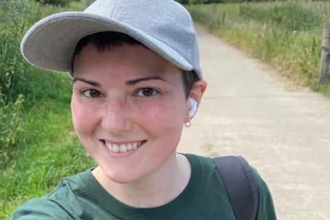 Female supporter taking a selfie out on a walk wearing an AN t-shirt and grey cap