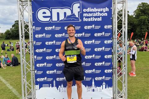 Anthony Nolan young male supporter at Edinburgh Marathon Festival with medal