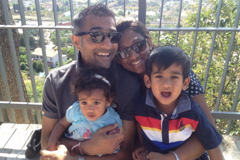 Poonam with her husband Rakesh with their two chilldren sat on their laps