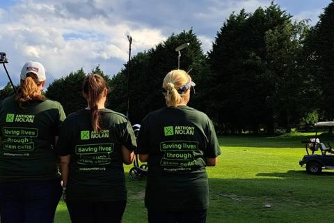 Three ladies holding golf clubs