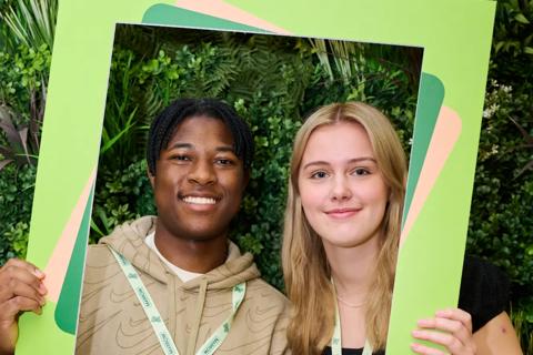 Students  smiling holding an  Anthony Nolan frame 