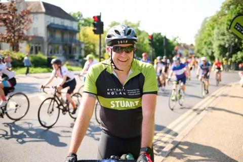 Anthony Nolan supporter smiling on his bike at the 2023 RideLondon