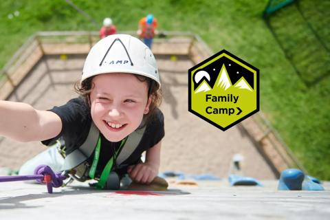 Young girl on a climbing wall at Family Camp