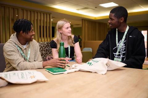 A photo of 3 Marrow volunteers sat around a table
