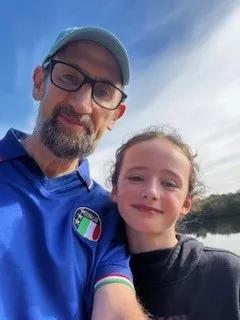 Man and his daughter smiling in the sunshine
