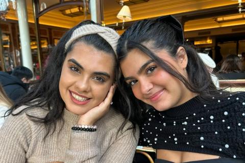 Natassa and Sofia sitting at a cafe table 