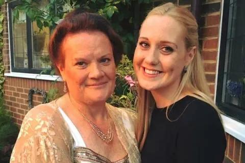 Megan and her mum hugging and smiling at the camera