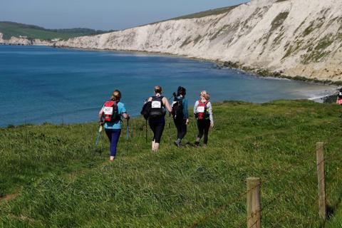 Photo of people walking along the Isle of Wight Coastline