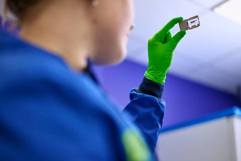 Researcher holding iSeq instrument