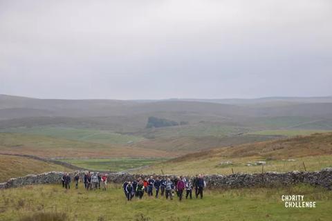 Photo from the Yorkshire 3 peaks challenge with misty horizon and people trekking