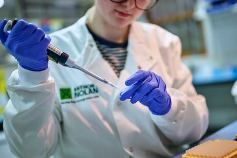 Researcher using a micropipette in a tube