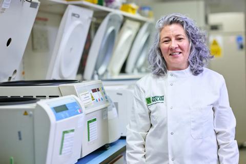 Researcher in a lab coat in a lab setting