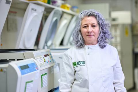 Researcher in a lab coat in a lab setting