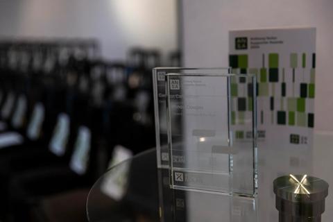 A photograph of the glass awards given at the 2024 ANSAs ceremony. The award is a clear glass square with the ANSA logo, winners name, award category and Anthony Nolan logo etched on the front.