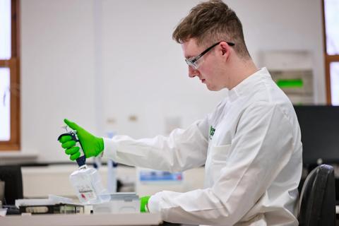 Researcher using a multichannel micropipette