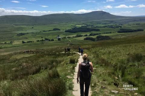 Photo of some peaks in Yorkshire and a woman trekking