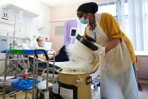 Healthcare professional opening a container with dry ice in a hospital room