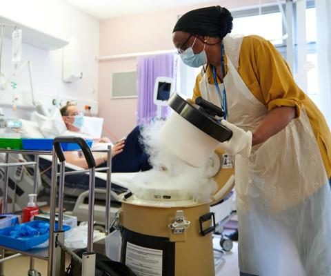 Healthcare professional opening a container with dry ice in a hospital room