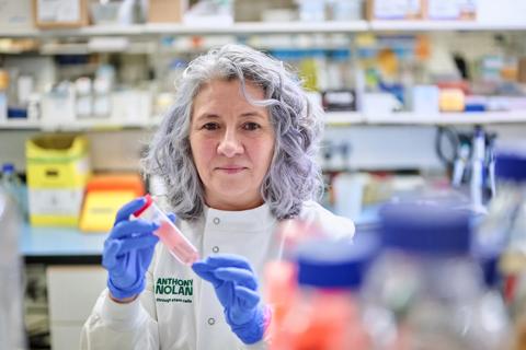 A researcher examining a stem cell sample in a lab setting