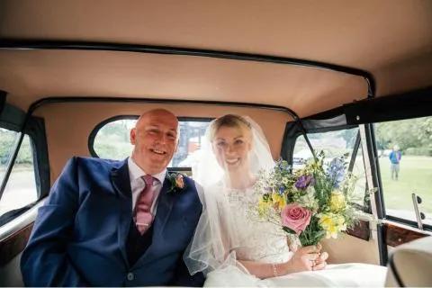 Nigel sat next to his daughter in the back of a wedding car on her wedding day