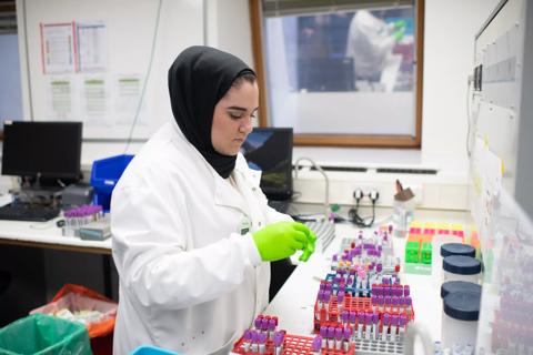Photo of a female Anthony Nolan Laboratory Scientist in a lab coat