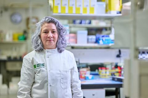 Researcher in a lab coat in a lab setting