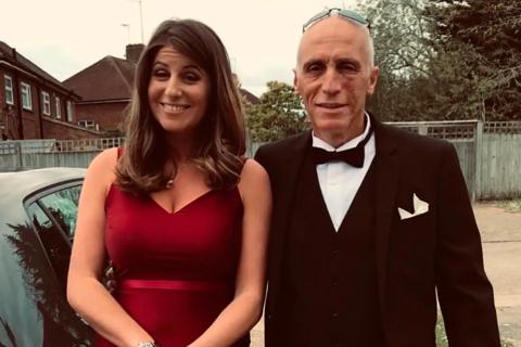 Michael on the right is an older man wearing a black suit and bowtie, Ellianna stands next to him wearing a red dress