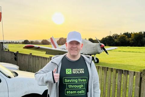 Skydiver next to plane