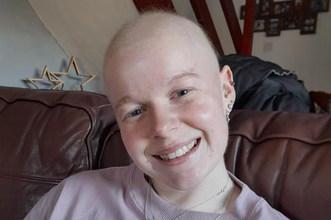 Emily with no hair due to chemo is waiting for a lifesaving stem cell donor