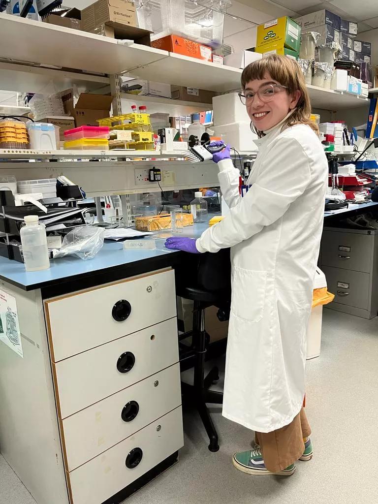 Researcher standing at lab bench